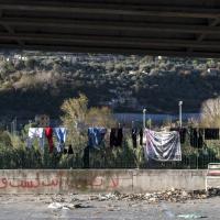 Geflüchtete Menschen haben ihre Kleidung auf einem Zaun aufgehängt. Foto: Michele Lapini