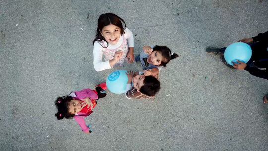 Kroatien: Vier Kinder spielen mit einem Luftballon und gucken nach oben. © Elisa Vandekerckhove