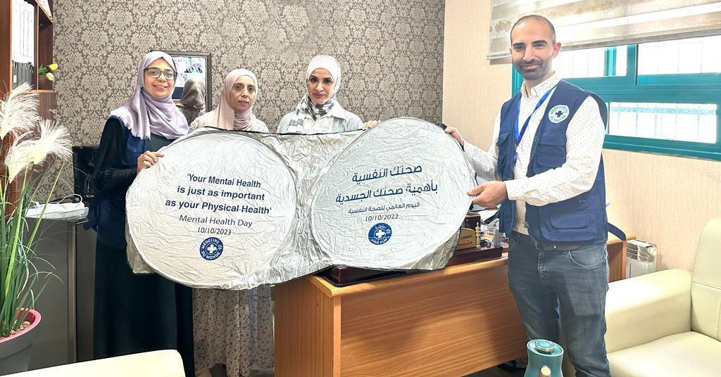 Mitarbeitende von Ärzte der Welt halten Schilder: Psychische Gesundheit ist so wichtig wie körperliche Gesundheit