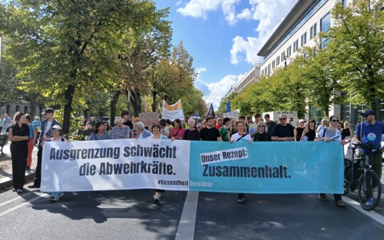 Demonstrationszug mit Banner der Kampagne "Gesundheit unteilbar". © Ärzte der Welt Demonstrationszug mit Banner der Kampagne "Gesundheit unteilbar". © Ärzte der Welt